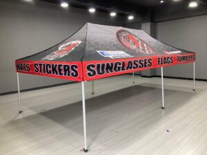 Vendor canopy tent printed for hats, stickers, sunglasses and flags