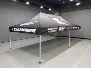 #TeamOneH race team canopy tent with sponsor logos