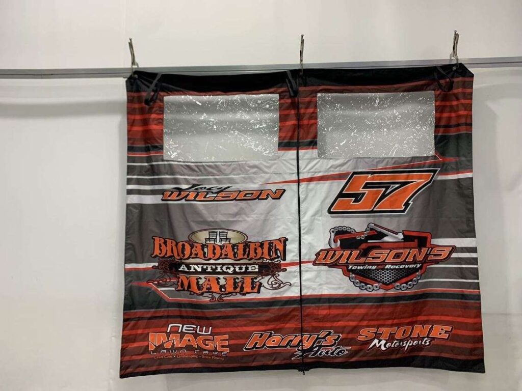 Joey Wilson #57 trailer curtain with sponsor graphics and clear windows